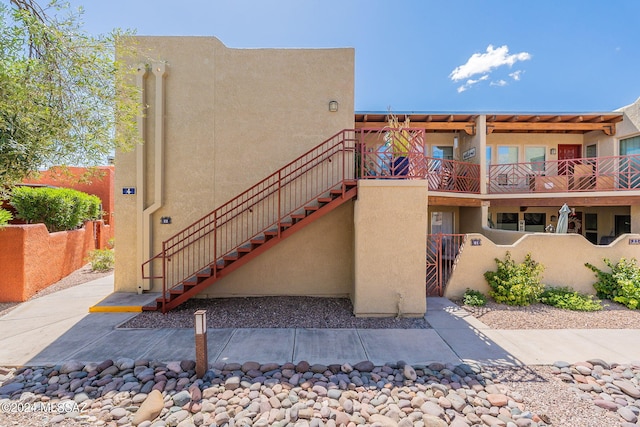 6255 N Camino Pimeria Alta Unit 22, Tucson, AZ 85718 - view of property exterior with stucco siding and stairway