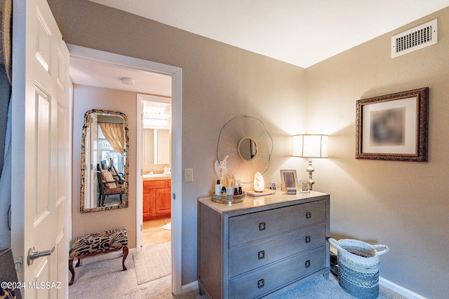 6255 N Camino Pimeria Alta Unit 22, Tucson, AZ 85718 - bedroom featuring light carpet, baseboards, and ensuite bath