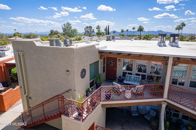6255 N Camino Pimeria Alta Unit 22, Tucson, AZ 85718 - view of exterior entry featuring stucco siding, a mountain view, and central AC