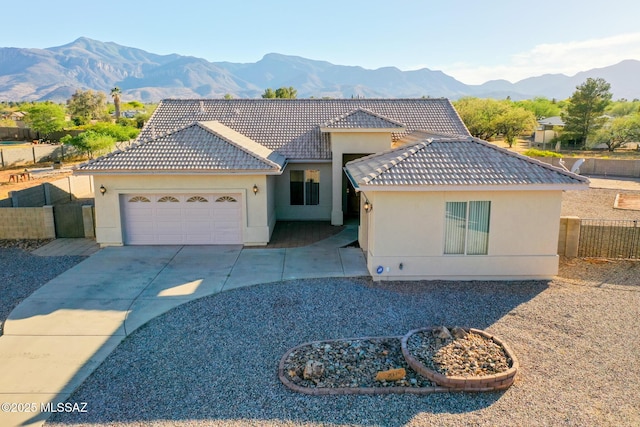 4210 S Santolina Ct, Sierra Vista, AZ 85650 - view of front of property featuring stucco siding, a garage, driveway, and a mountain view
