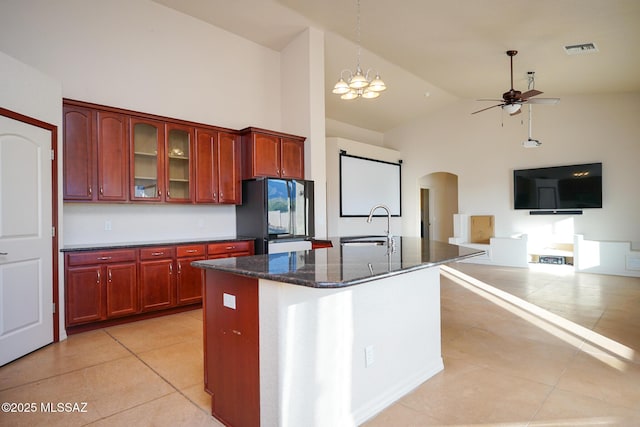 4210 S Santolina Ct, Sierra Vista, AZ 85650 - kitchen with freestanding refrigerator, arched walkways, light tile patterned floors, a ceiling fan, and high vaulted ceiling