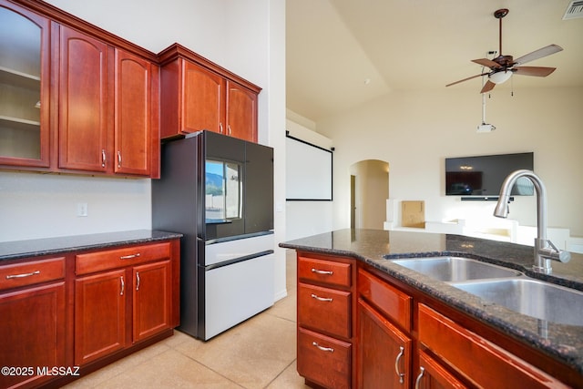 4210 S Santolina Ct, Sierra Vista, AZ 85650 - kitchen featuring arched walkways, a sink, ceiling fan, dark stone counters, and vaulted ceiling
