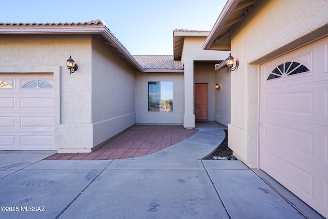 4210 S Santolina Ct, Sierra Vista, AZ 85650 - property entrance featuring a garage, stucco siding, and a tile roof