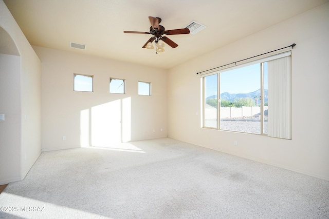 4210 S Santolina Ct, Sierra Vista, AZ 85650 - empty room featuring plenty of natural light, arched walkways, carpet flooring, and ceiling fan