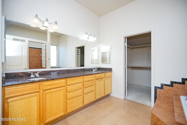 4210 S Santolina Ct, Sierra Vista, AZ 85650 - full bathroom with double vanity, tiled bath, tile patterned flooring, and a spacious closet