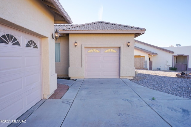 4210 S Santolina Ct, Sierra Vista, AZ 85650 - view of front of home featuring stucco siding, a tiled roof, a garage, and driveway