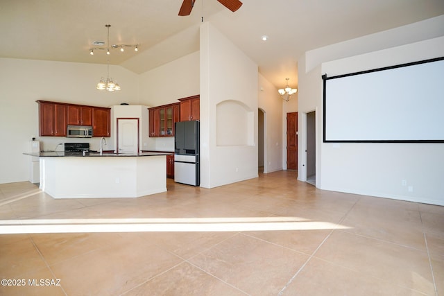 4210 S Santolina Ct, Sierra Vista, AZ 85650 - kitchen with stainless steel microwave, freestanding refrigerator, a chandelier, high vaulted ceiling, and ceiling fan