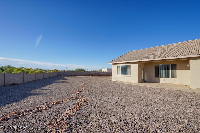 4210 S Santolina Ct, Sierra Vista, AZ 85650 - back of house with a fenced backyard, stucco siding, a tile roof, and a patio area