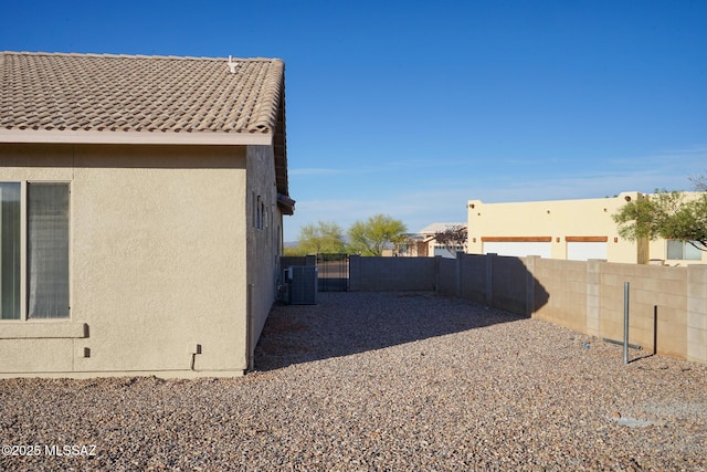4210 S Santolina Ct, Sierra Vista, AZ 85650 - view of home's exterior with stucco siding, central AC unit, and a tile roof