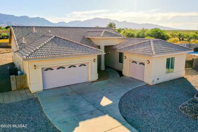 4210 S Santolina Ct, Sierra Vista, AZ 85650 - view of front of home featuring an attached garage, a mountain view, a tiled roof, and driveway