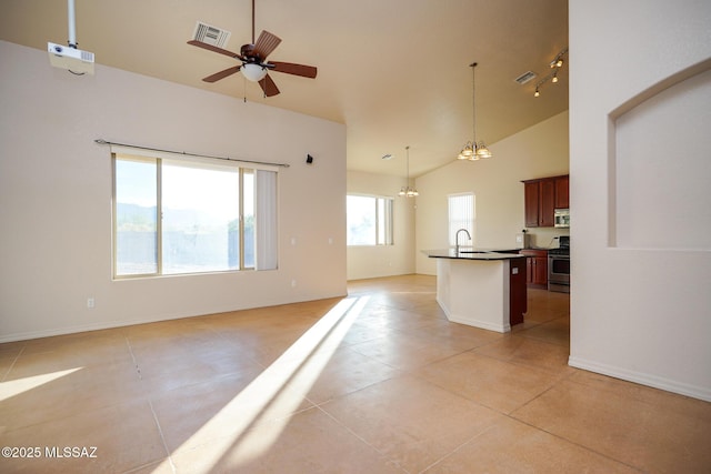 4210 S Santolina Ct, Sierra Vista, AZ 85650 - kitchen with dark countertops, open floor plan, stainless steel appliances, light tile patterned floors, and an island with sink