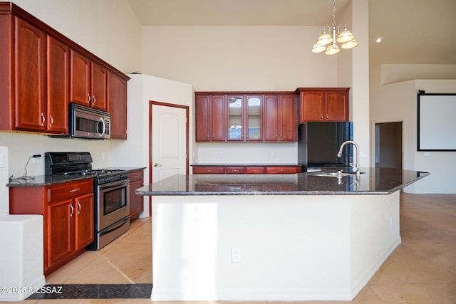4210 S Santolina Ct, Sierra Vista, AZ 85650 - kitchen with appliances with stainless steel finishes, light tile patterned flooring, dark brown cabinets, a towering ceiling, and dark stone counters