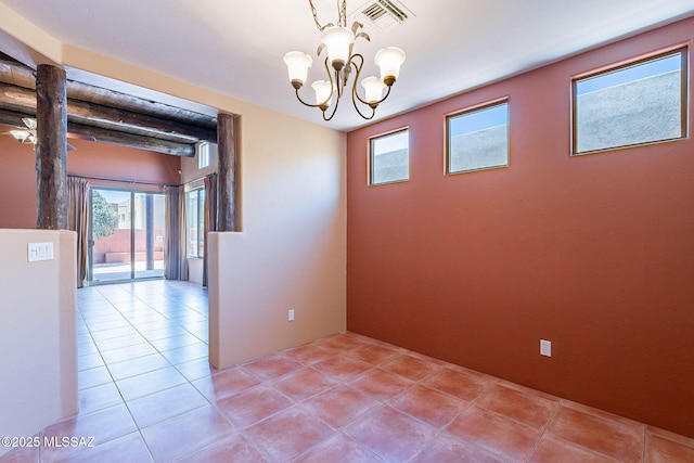 11315 N Mountain Meadow Pl, Oro Valley, AZ 85737 - empty room with light tile patterned floors, a chandelier, and plenty of natural light