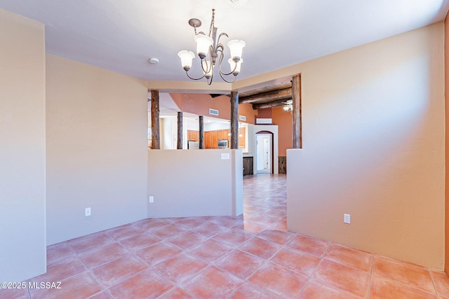 11315 N Mountain Meadow Pl, Oro Valley, AZ 85737 - empty room with a chandelier and light tile patterned flooring