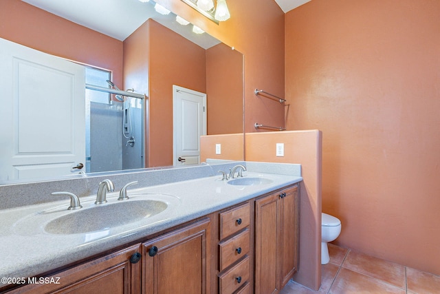 11315 N Mountain Meadow Pl, Oro Valley, AZ 85737 - bathroom featuring toilet, double vanity, tile patterned flooring, and a shower with door