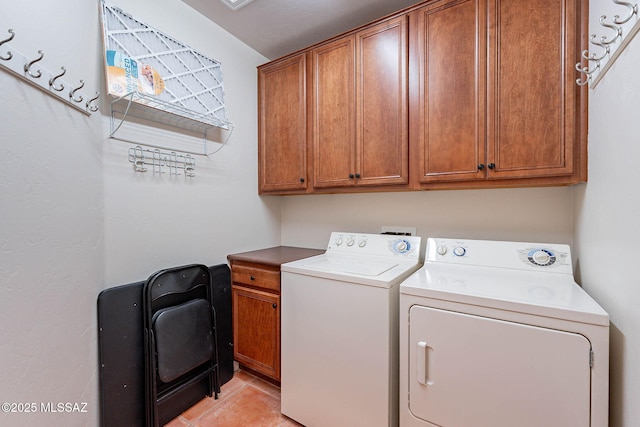 11315 N Mountain Meadow Pl, Oro Valley, AZ 85737 - laundry room featuring cabinet space, washer and clothes dryer, and light tile patterned floors