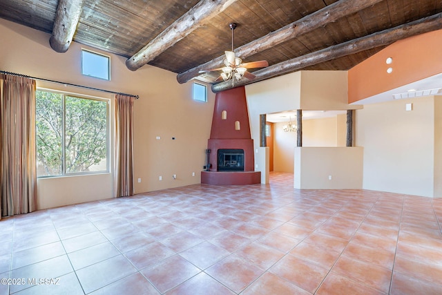 11315 N Mountain Meadow Pl, Oro Valley, AZ 85737 - unfurnished living room featuring wood ceiling with exposed beams, a large fireplace, tile patterned floors, ceiling fan, and a towering ceiling