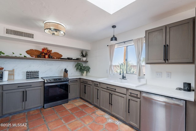 9845 N Volk Ave, Marana, AZ 85653 - kitchen featuring stainless steel appliances, open shelves, gray cabinets, a sink, and light countertops