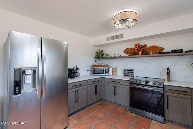 9845 N Volk Ave, Marana, AZ 85653 - kitchen featuring stainless steel appliances, open shelves, gray cabinets, backsplash, and light countertops