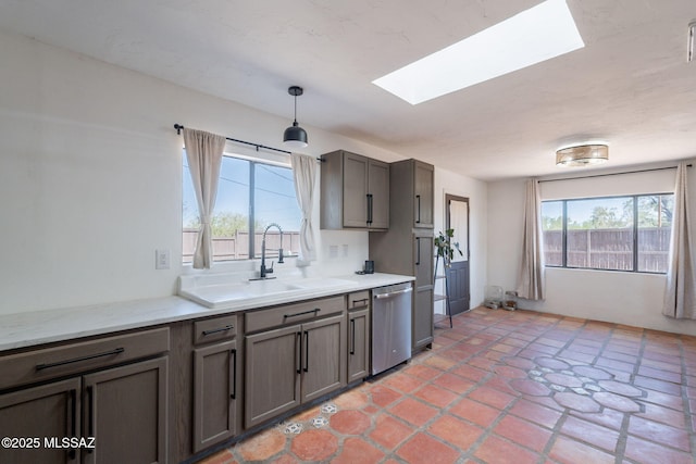 9845 N Volk Ave, Marana, AZ 85653 - kitchen with dishwasher, a skylight, plenty of natural light, and a sink