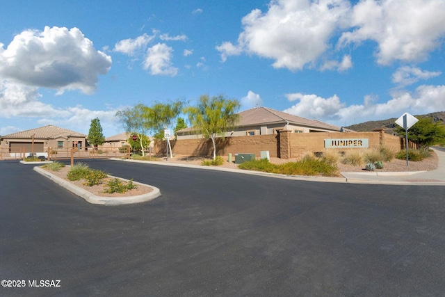 8880 W Blakebrook Rd, Marana, AZ 85653 - view of asphalt road with traffic signs, curbs, and sidewalks