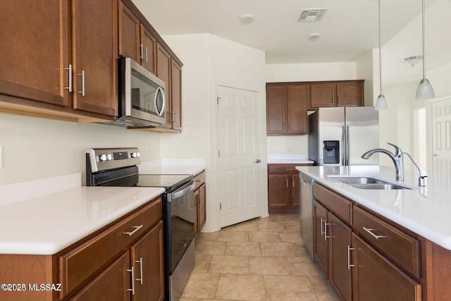8880 W Blakebrook Rd, Marana, AZ 85653 - kitchen featuring appliances with stainless steel finishes, a sink, light countertops, and pendant lighting