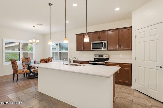 8880 W Blakebrook Rd, Marana, AZ 85653 - kitchen featuring stainless steel appliances, a sink, light countertops, decorative light fixtures, and a chandelier