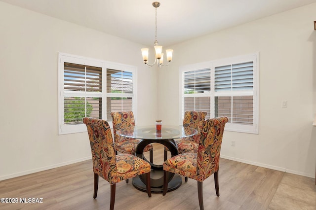 8880 W Blakebrook Rd, Marana, AZ 85653 - dining room with a chandelier, light wood-style flooring, and baseboards
