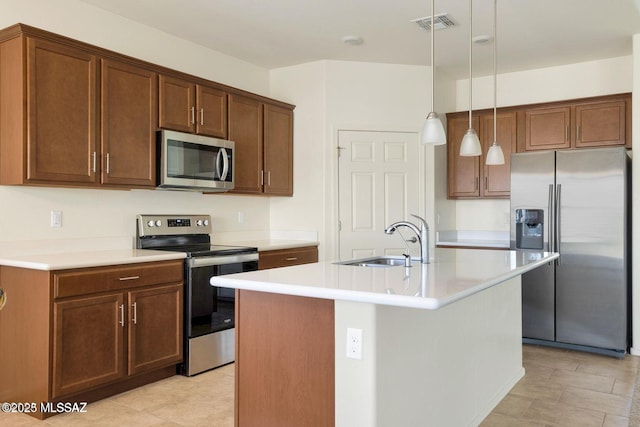 8880 W Blakebrook Rd, Marana, AZ 85653 - kitchen with stainless steel appliances, a sink, light countertops, a kitchen island with sink, and hanging light fixtures