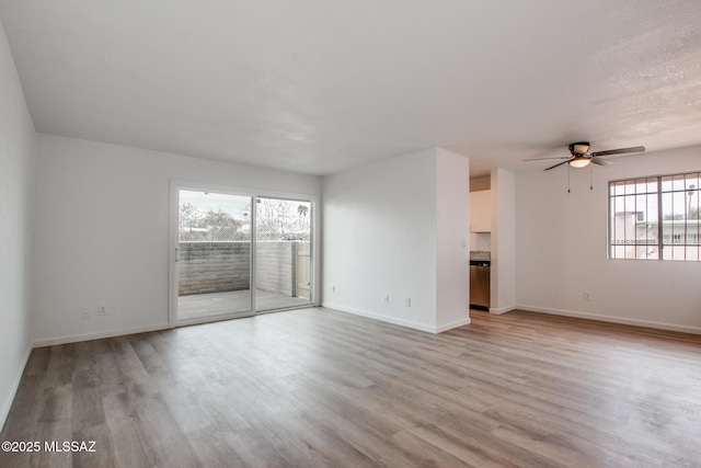 828 S Langley Ave Unit 101, Tucson, AZ 85710 - unfurnished living room featuring plenty of natural light, light wood finished floors, and ceiling fan