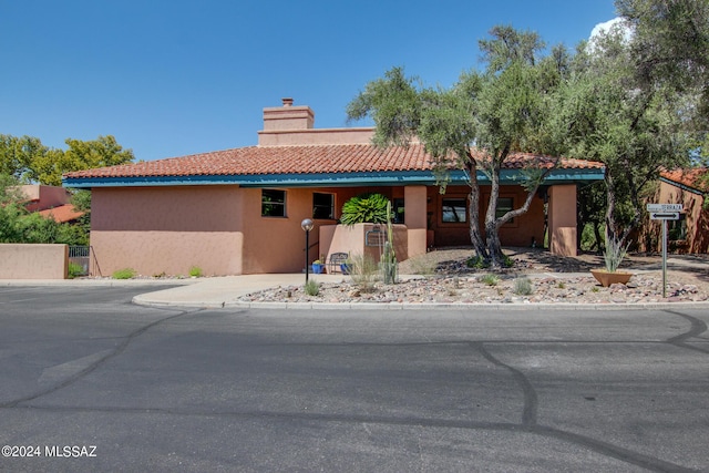 5357 N Paseo De La Terraza, Tucson, AZ 85750 - view of front of home featuring a chimney, stucco siding, driveway, and a tile roof