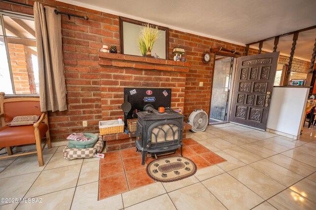 517 Kino Springs Dr, Nogales, AZ 85621 - living room featuring a wood stove, tile patterned floors, and brick wall