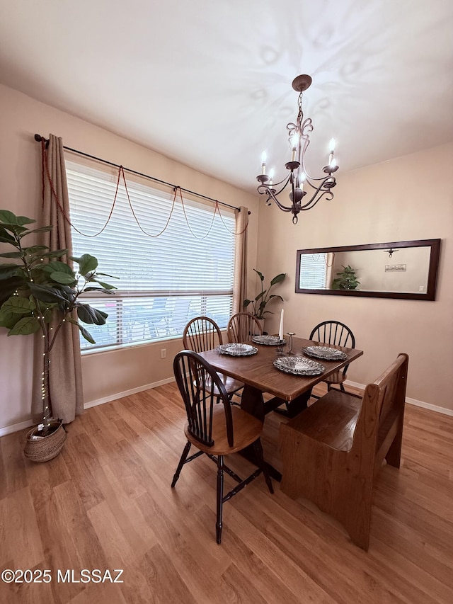 15415 S Camino Agua Azul, Sahuarita, AZ 85629 - dining area featuring a chandelier, wood finished floors, and baseboards