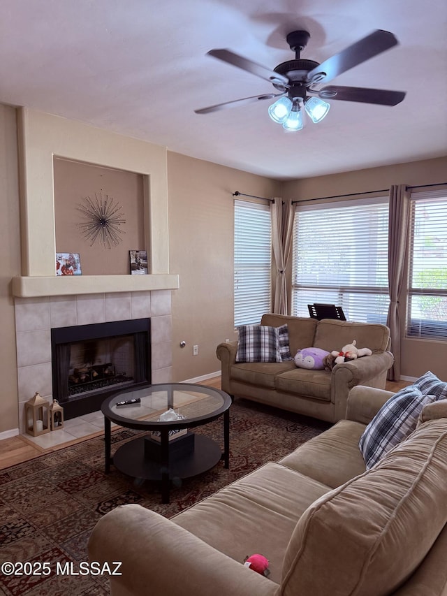 15415 S Camino Agua Azul, Sahuarita, AZ 85629 - living area featuring baseboards, a ceiling fan, and a tiled fireplace