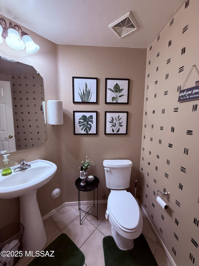 15415 S Camino Agua Azul, Sahuarita, AZ 85629 - half bathroom with toilet, tile patterned flooring, baseboards, and a sink
