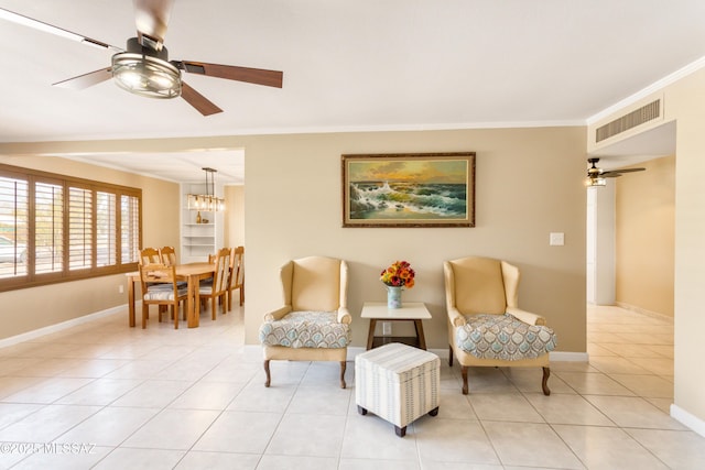 5826 E Hawthorne St, Tucson, AZ 85711 - living area with crown molding, ceiling fan, light tile patterned floors, baseboards, and a chandelier