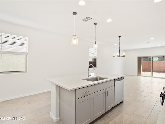 13097 N Farmhouse Ln, Marana, AZ 85653 - kitchen with dishwasher, a sink, a center island with sink, a chandelier, and light countertops