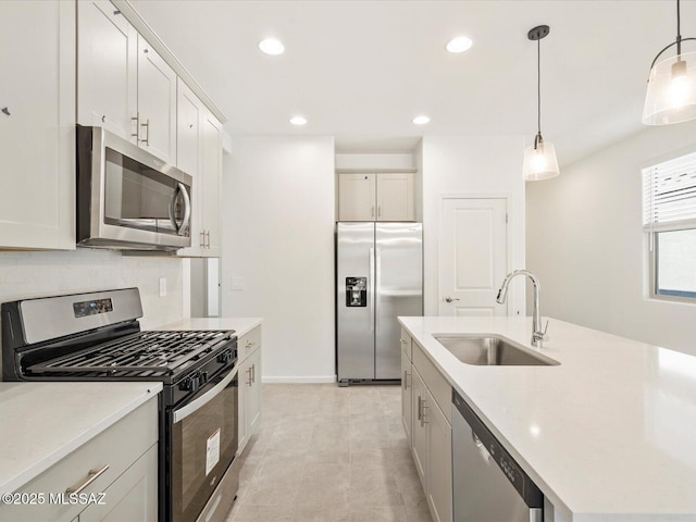 13097 N Farmhouse Ln, Marana, AZ 85653 - kitchen with appliances with stainless steel finishes, a sink, light countertops, pendant lighting, and tasteful backsplash