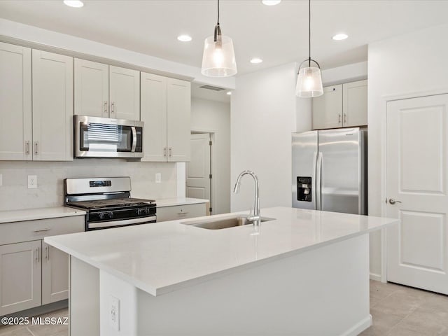 13097 N Farmhouse Ln, Marana, AZ 85653 - kitchen featuring stainless steel appliances, a sink, decorative backsplash, a kitchen island with sink, and pendant lighting