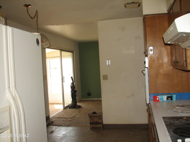 487 E Patrick Dr, Benson, AZ 85602 - kitchen featuring white fridge with ice dispenser, ventilation hood, black electric stovetop, and baseboards