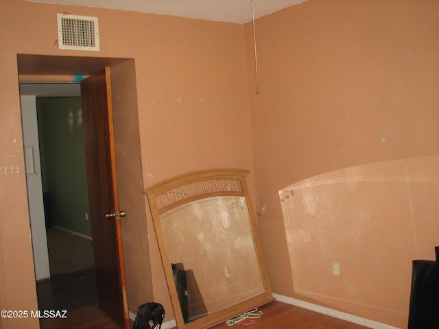 487 E Patrick Dr, Benson, AZ 85602 - empty room with wood finished floors and baseboards