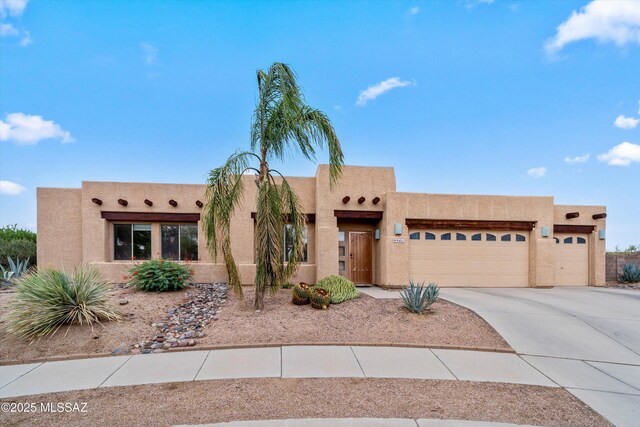 9401 E Sandy Whiskers Pl, Tucson, AZ 85710 - adobe home featuring a garage, driveway, and stucco siding
