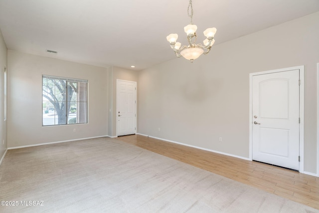 12970 N Topanga Dr, Tucson, AZ 85755 - carpeted empty room with a chandelier, baseboards, and wood finished floors