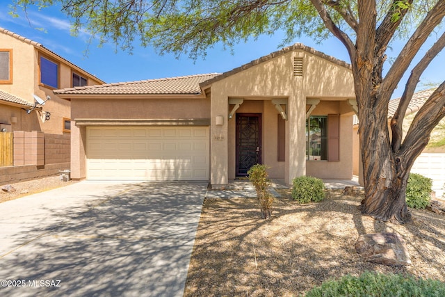 12970 N Topanga Dr, Tucson, AZ 85755 - view of front of home featuring stucco siding, a tiled roof, a garage, and driveway