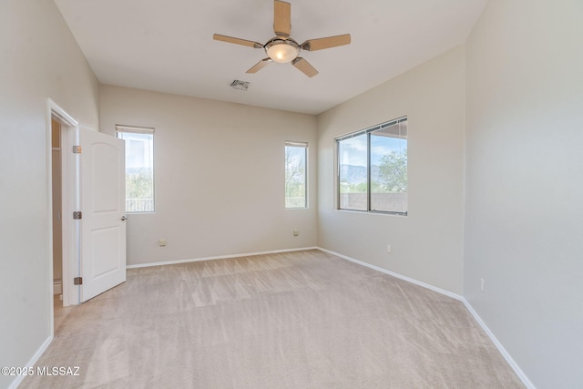 12970 N Topanga Dr, Tucson, AZ 85755 - spare room with a ceiling fan, healthy amount of natural light, light carpet, and baseboards