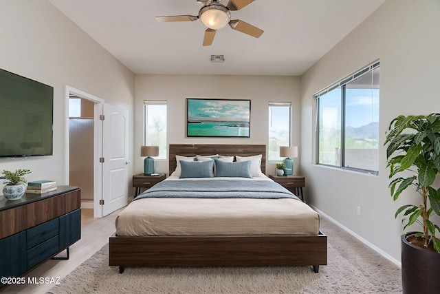 12970 N Topanga Dr, Tucson, AZ 85755 - bedroom featuring baseboards, a ceiling fan, and light colored carpet