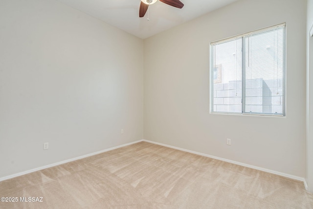 12970 N Topanga Dr, Tucson, AZ 85755 - empty room featuring light colored carpet, a ceiling fan, baseboards, and healthy amount of natural light