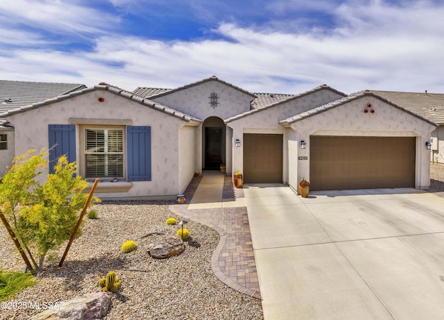 62146 E Marble Dr, Oracle, AZ 85623 - mediterranean / spanish-style home with a garage, driveway, and stucco siding