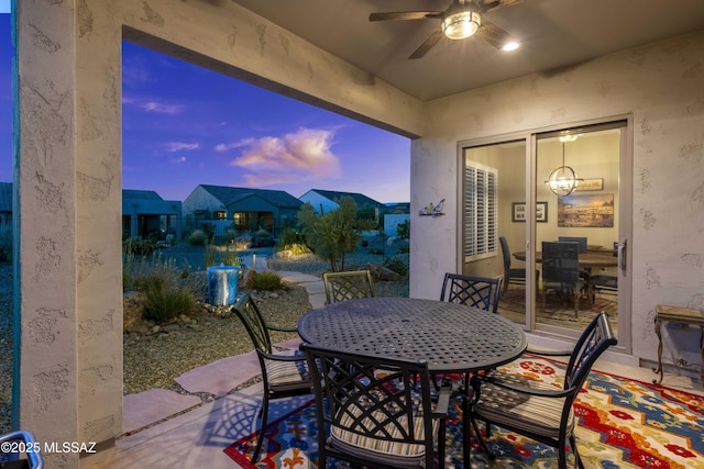 62146 E Marble Dr, Oracle, AZ 85623 - patio terrace at dusk featuring outdoor dining space, a ceiling fan, and a patio