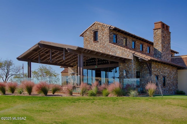 62146 E Marble Dr, Oracle, AZ 85623 - back of house featuring a chimney, a lawn, and stone siding